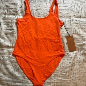 Girlfriend Collective orange one piece